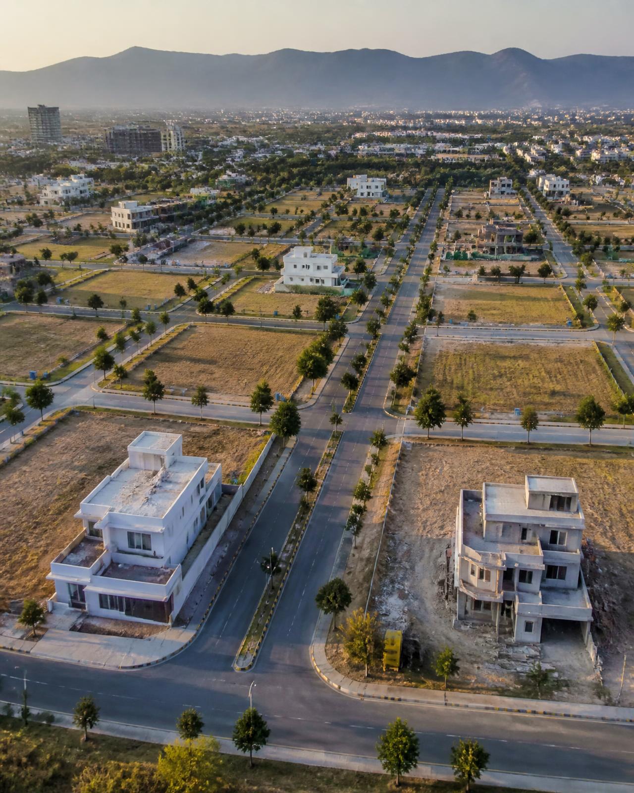 Aerial view of Sector I-12 Islamabad showing completed CDA roads, demarcated plots and houses under construction